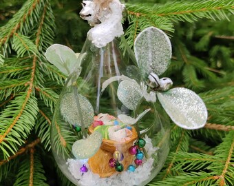 Baby mice asleep in mistletoe glass bauble