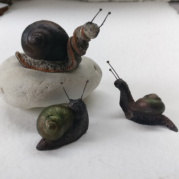 Magical colour changing snail sculpture figurine.