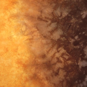 Hand dyed quilting cotton gradient in shades of tan and warm golden brown shading to deep brown