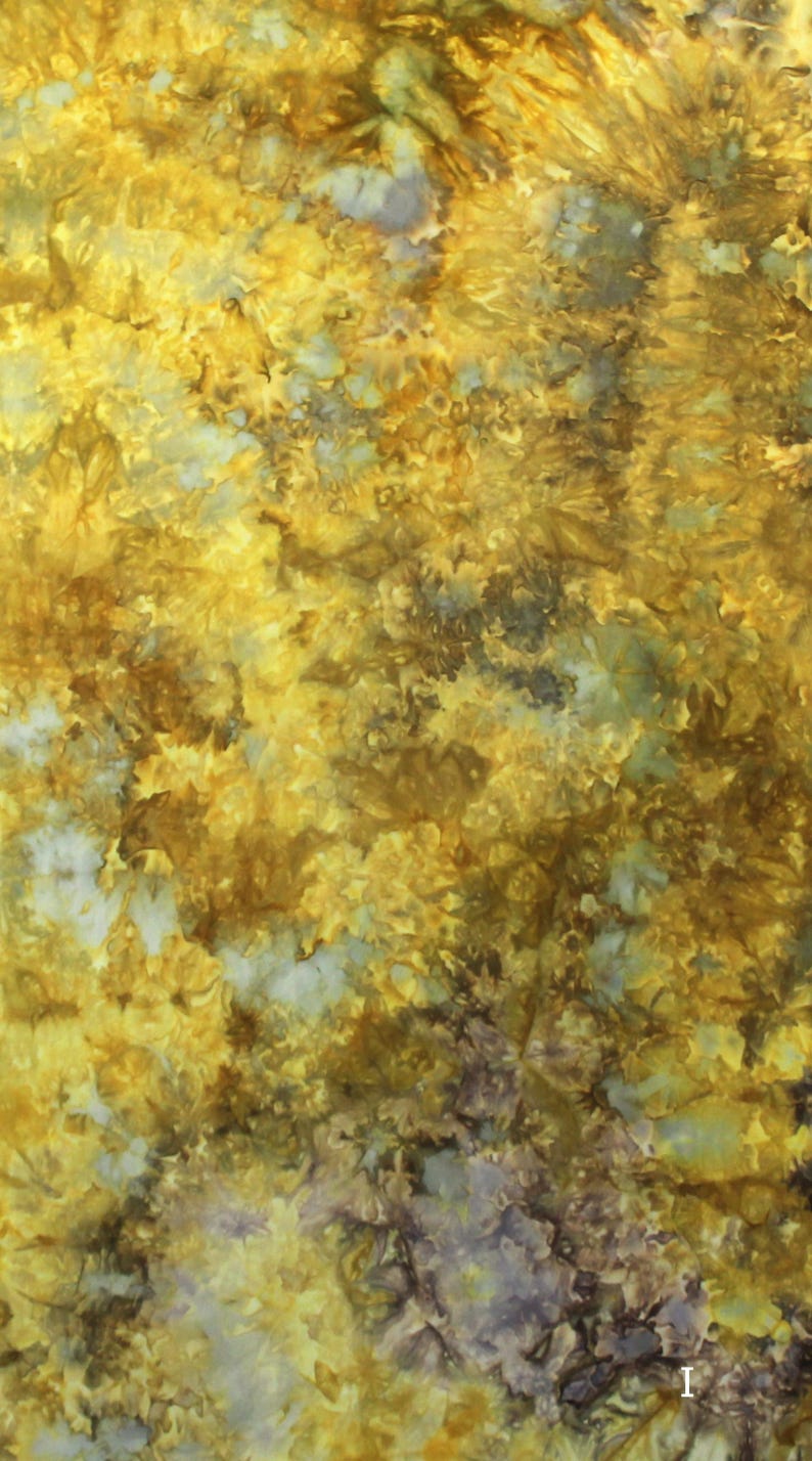 May include: A textile fabric featuring a tie-dye pattern with a blend of golden yellow, mustard, and deep brown hues, interspersed with subtle patches of pale grey and white, creating a textured, organic, and mottled appearance across the surface.