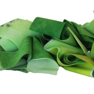 Scrap bundle of quilting cotton strips in shades of yellow green, 2.5 inches wide, length varies, 6 oz bundle, ready to ship