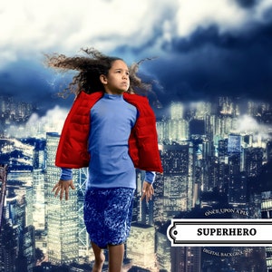 Puede incluir: Una persona joven con una chaqueta roja y pantalones azules se encuentra frente a un horizonte urbano. La persona mira hacia la derecha. El texto "Once Upon A Pix Superhero Digital Background" está en la parte inferior de la imagen.