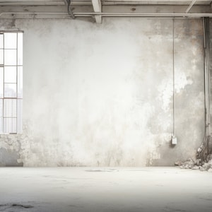 May include: A large, empty room with exposed brick walls, a concrete floor, and two large windows. The walls are painted white and have a distressed look. The windows are made of glass and have metal frames. The room is lit by natural light coming in through the windows.