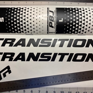 May include: Two black and white stickers with the text "PBJ Pumps, Bumps, Jumps" and "SHORT" and "LONG" on them. The stickers have a black and white triangle pattern. Two black stickers with the text "TRANSITION" on them.