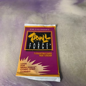 May include: A purple and yellow package of Troll Force trading cards. The package features a cartoon troll with a star and the text "Troll Force" in bold letters. The package includes 7 collectible cards and 1 sticker. The text "Look for Troll Force Comic Strip Cards!!!" is printed on the bottom of the package.