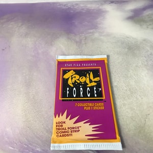 May include: A purple and yellow card pack with the text "STAR PICS PRESENTS TROLL FORCE" and "7 COLLECTIBLE CARDS PLUS 1 STICKER". The pack also has the text "LOOK FOR TROLL FORCE™ COMIC STRIP CARDS!!!"