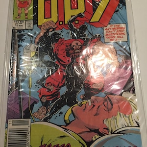 May include: A comic book cover featuring a red and black character with a beard, holding a large, black, clawed hand. The cover text reads "DP7" and "KILLING AT THE CLINIC!" with a smaller text box that reads "IF THE ANTIBODIES CAN'T STOP MASTODON, THERE WILL BE A--".