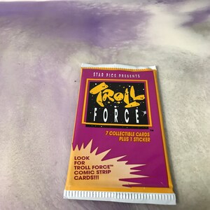 May include: A purple and yellow card pack with the text "STAR PICS PRESENTS TROLL FORCE" and "7 COLLECTIBLE CARDS PLUS 1 STICKER". The pack also has the text "LOOK FOR TROLL FORCE™ COMIC STRIP CARDS!!!".
