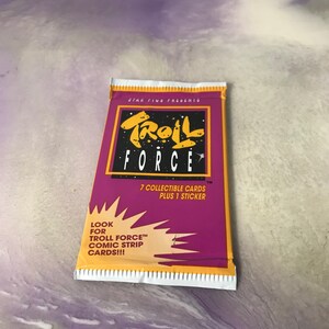 May include: A purple and yellow card pack with the text "Troll Force" and "7 collectible cards plus 1 sticker". The pack also says "Look for Troll Force comic strip cards!!!"