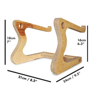 May include: A wooden laptop stand with a natural finish. The stand is 7 inches tall, 8.2 inches wide, and 9.5 inches deep.