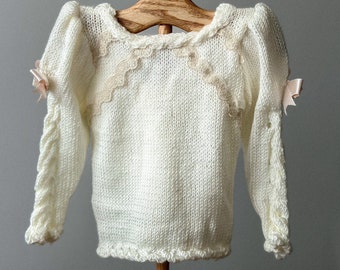 Elegant Hand-Knit Ivory Sweater for Baby Girl with Blush Peach Satin Ribbon and Pearls. Ready to ship!