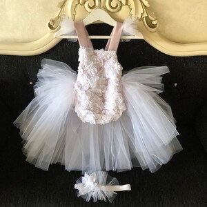 Sweet and chic blush pink and white romper with delicate lace, 3D flowers, pearl shoes, and coordinating headband