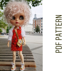 May include: A doll with pink hair wearing a red and white dress with a gold strap and a small gold bag. The doll is wearing white sneakers with gold accents. The doll is standing on a wooden surface.