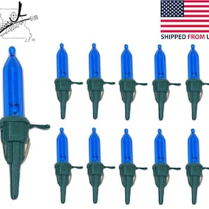 May include: A set of 12 blue Christmas lights with green wire clips. The lights are shaped like a traditional Christmas bulb and have a clear glass casing.