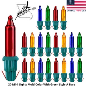 Pode incluir: Um conjunto de 20 mini luzes multicoloridas com bases verdes. As luzes são vermelhas, amarelas, azuis e verdes. O texto na parte inferior diz "20 Mini Lights Multi Color With Green Style A Base".