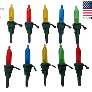 May include: Assortment of 12 mini Christmas lights with green wire bases. The lights are red, blue, green, and yellow.