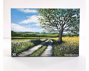 Könnte beinhalten: Originales Landschaftsgemälde, das einen Feldweg durch eine Wildblumenwiese zeigt, der zu einem Baum führt. Der Himmel ist blau mit weißen Wolken. Das Gemälde ist mit "MS" signiert und enthält den Text "@MSTEWARTPAINTINGS".