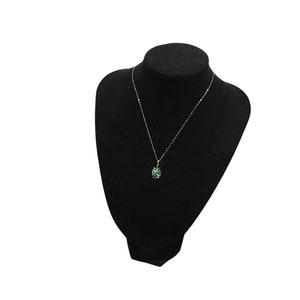 a vintage gold emerald and brilliant cut diamond pendant with a gold chain