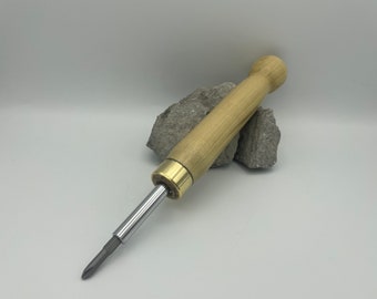 May include: A wooden handled screwdriver with a brass ferrule and a silver metal shaft.