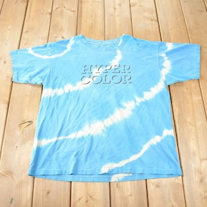 May include: A blue tie-dye t-shirt with the words "HYPER COLOR" printed in white on the front.