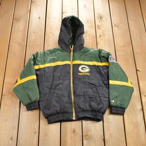 May include: Green and black reversible puffer jacket with a yellow stripe and the Green Bay Packers logo. The jacket has a hood and a zipper closure.