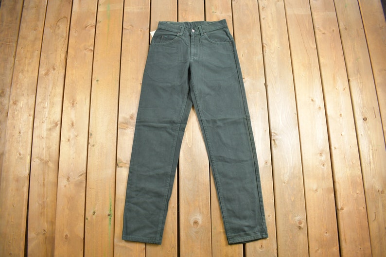 May include: A pair of dark green pants with a straight leg fit.