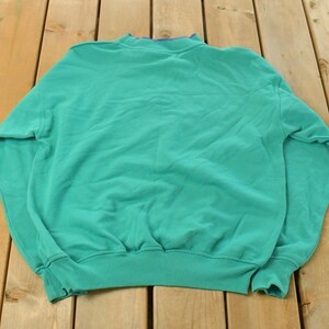 May include: A rustic wooden sign with the text "Welcome to our home" in white lettering. The sign features a distressed finish and a simple, inviting design, perfect for front door decor.