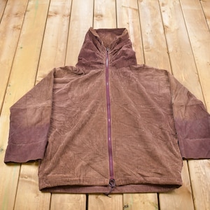May include: A brown corduroy hooded jacket with a zipper closure. The jacket has a drawstring at the bottom and is made of a soft, comfortable fabric.