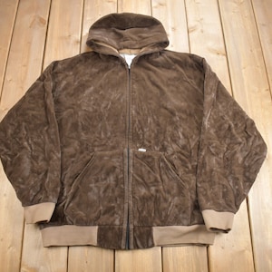 May include: A brown corduroy hooded sweatshirt with a zipper closure. The sweatshirt has a tan colored lining and a tan colored waistband.