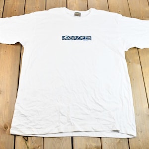 Camiseta vintage de atletismo Roots con logotipo gráfico de stock muerto, años 90. Fabricada en Canadá. Ropa deportiva vintage Roots. Ropa urbana. Ropa vintage canadiense.