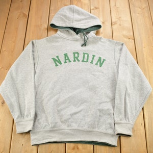 May include: Grey hooded sweatshirt with a green inner lining and the word "NARDIN" printed in green on the front.