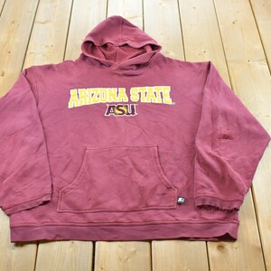 May include: A maroon hooded sweatshirt featuring the text ARIZONA STATE in yellow lettering and the ASU logo in yellow and white. The garment includes a front kangaroo pocket, long sleeves with ribbed cuffs, and a small Starter brand logo tag.