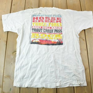 Vintage 1990s Marlboro Unlimited Graphic T Shirt Size XL / Pocket Tee / Graphic Tee / Made In USA / Distressed