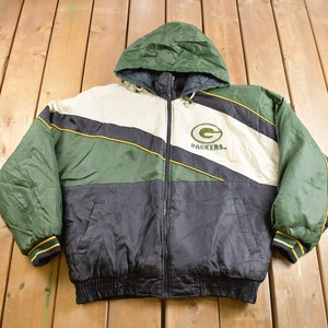 May include: Green Bay Packers reversible jacket with a black, green, and white color block design. The jacket has a zipper closure, a hood, and the team logo on the front.