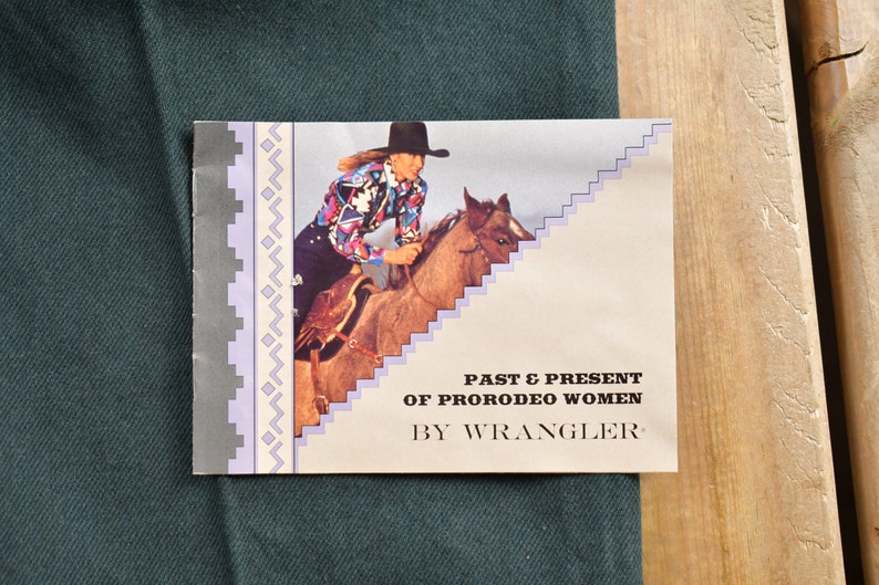 Op de afbeelding: Een vintage pamflet dat Wrangler jeans adverteert met een foto van een vrouw die paardrijdt. De tekst luidt "Past & Present of ProRodeo Women by Wrangler."