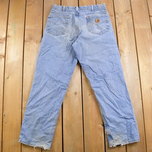 May include: A pair of light blue denim jeans with a brown leather patch on the back pocket.