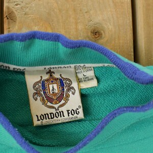 May include: A set of three ceramic mugs with a speckled, matte finish. The mugs are in shades of cream, light gray, and dark gray. Each mug has a simple, minimalist design, perfect for coffee or tea.