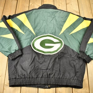 May include: A black, green, and yellow reversible jacket with a large green "G" on the back. The jacket has a zipper closure and a drawstring waist.