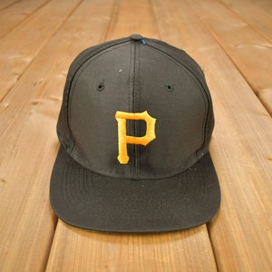 May include: A black baseball cap with a yellow "P" embroidered on the front.