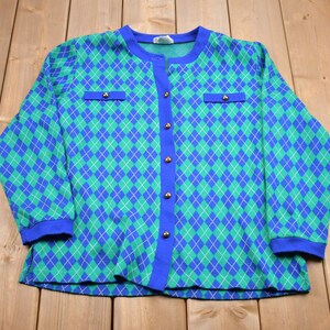 May include: A blue and green argyle patterned cardigan with a button front and long sleeves.
