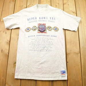 May include: A gray t-shirt with the text "Super Bowl XXV National Football League Silver Anniversary Game" and a graphic of the Super Bowl logo. The shirt also has a small NFL logo patch on the bottom right.