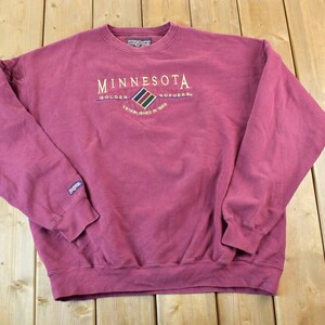 May include: A maroon sweatshirt with the text "Minnesota Golden Gophers Established in 1899" embroidered on the front.