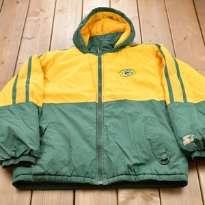 May include: Green and yellow hooded jacket with a zipper closure and a team logo on the front. The jacket has a green and yellow striped design on the sleeves and a Starter logo on the right sleeve.