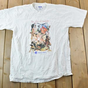 May include: White t-shirt with a graphic of a variety of animals and the text "The Show of Animals" and "Ontario SPCA".