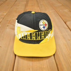 May include: Black and yellow baseball cap with a white and black Steelers logo and the word "Steelers" in yellow letters.