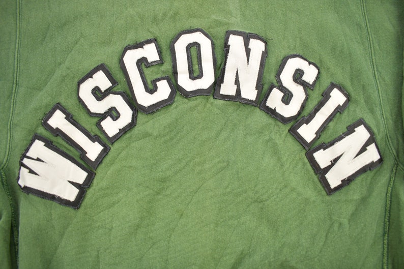 May include: Green sweatshirt with a white felt "WISCONSIN" patch on the back.