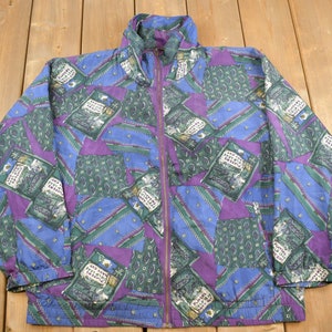 May include: A blue, green, and purple patterned jacket with a zipper closure. The jacket has a stand-up collar and long sleeves.