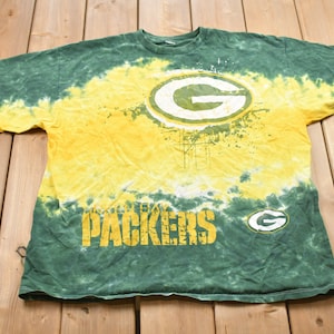 May include: Green and yellow tie-dye t-shirt with a green and white Green Bay Packers logo and the words "Green Bay Packers" in black.