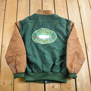 May include: Green and brown varsity jacket with "Casino Niagara" embroidered on the back.