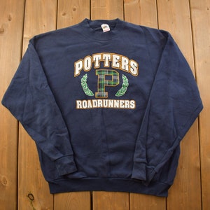 May include: A navy blue sweatshirt with a white, green and orange embroidered logo that says "Potters Roadrunners" with a plaid "P" inside a wreath.